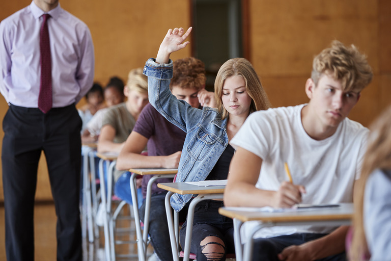teenage student sitting examination asking teacher 2023 11 27 05 23 35 utc